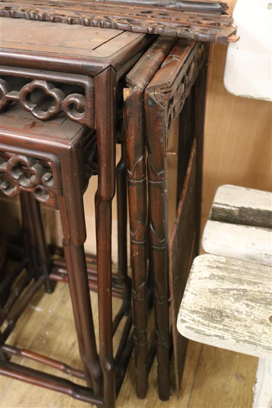 A Chinese nest of three carved hardwood tea tables, each with pierced frieze W.45cm approx.